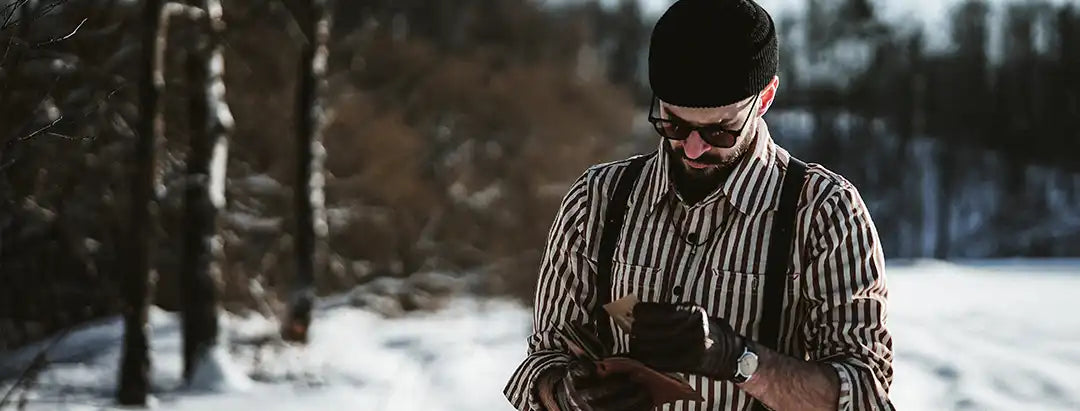 Man standing in snowy forest wearing wiseguy original suspenders