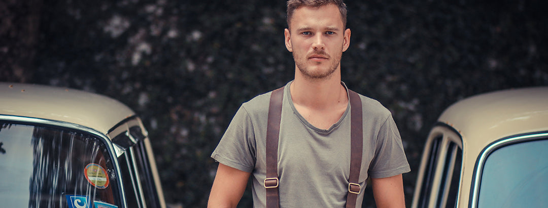 Guy wearing brown leather Wiseguy Suspenders between cars