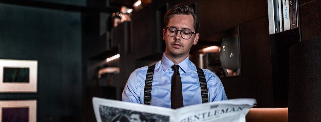 Man reading paper and wearing Wiseguy Suspenders